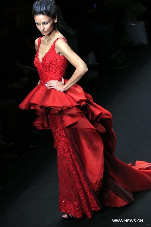 A model presents a wedding gown designed by Peng Jing during China Fashion Week in Beijing, capital of China, Oct. 26, 2014. 