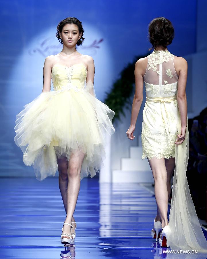 A model presents a wedding gown designed by Ren Chunhua during China Fashion Week in Beijing, capital of China, Oct. 26, 2014.