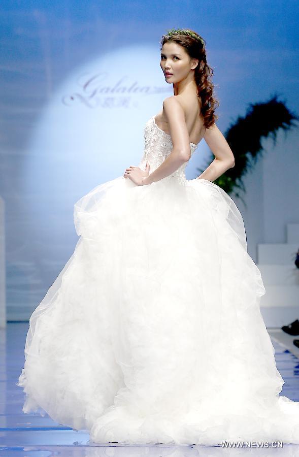 A model presents a wedding gown designed by Ren Chunhua during China Fashion Week in Beijing, capital of China, Oct. 26, 2014. 