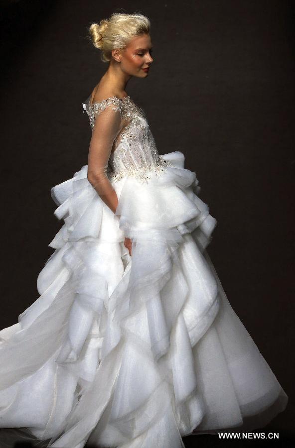 A model presents a wedding gown designed by Peng Jing during China Fashion Week in Beijing, capital of China, Oct. 26, 2014.