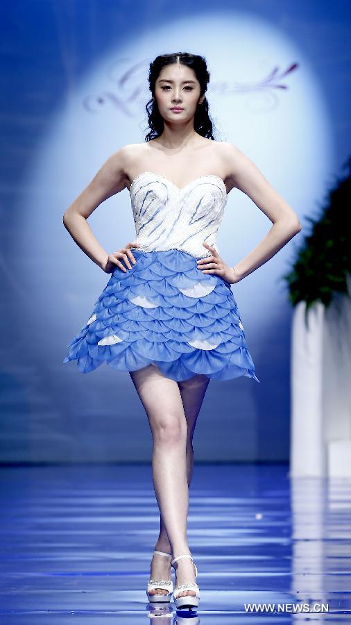 A model presents a wedding gown designed by Ren Chunhua during China Fashion Week in Beijing, capital of China, Oct. 26, 2014. 