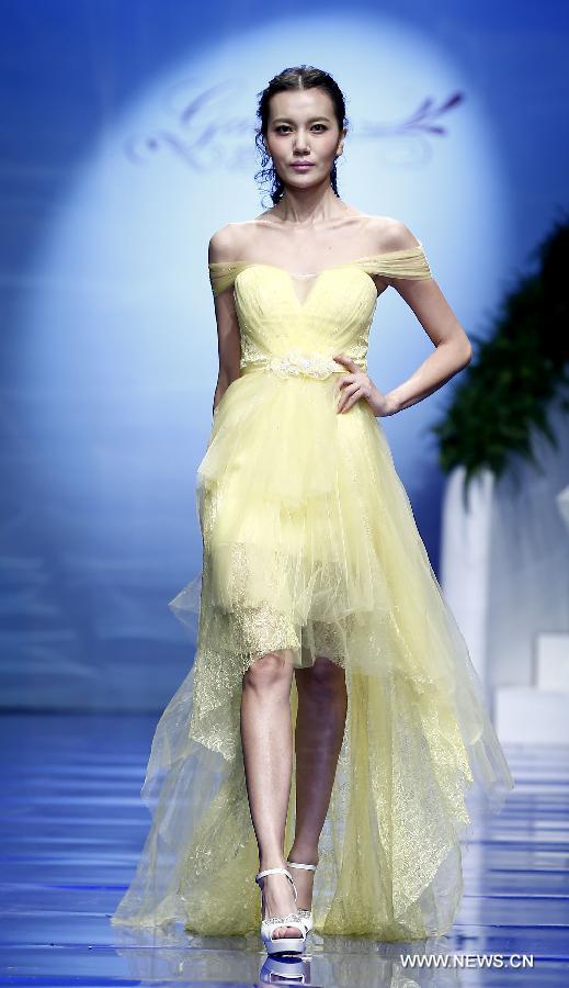 A model presents a wedding gown designed by Ren Chunhua during China Fashion Week in Beijing, capital of China, Oct. 26, 2014.