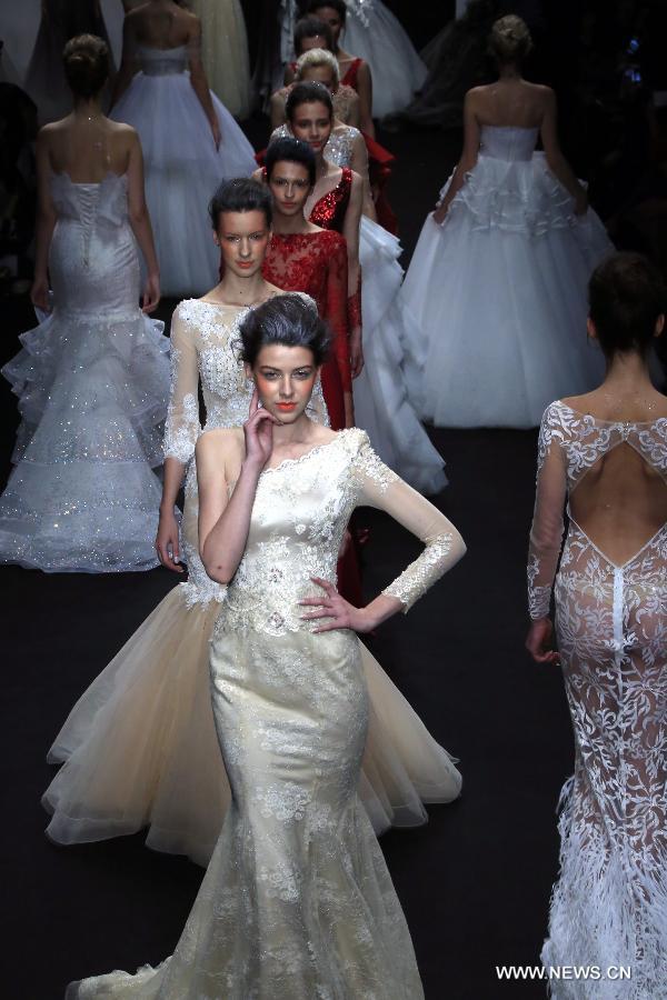 Models present wedding gowns designed by Peng Jing during China Fashion Week in Beijing, capital of China, Oct. 26, 2014. 