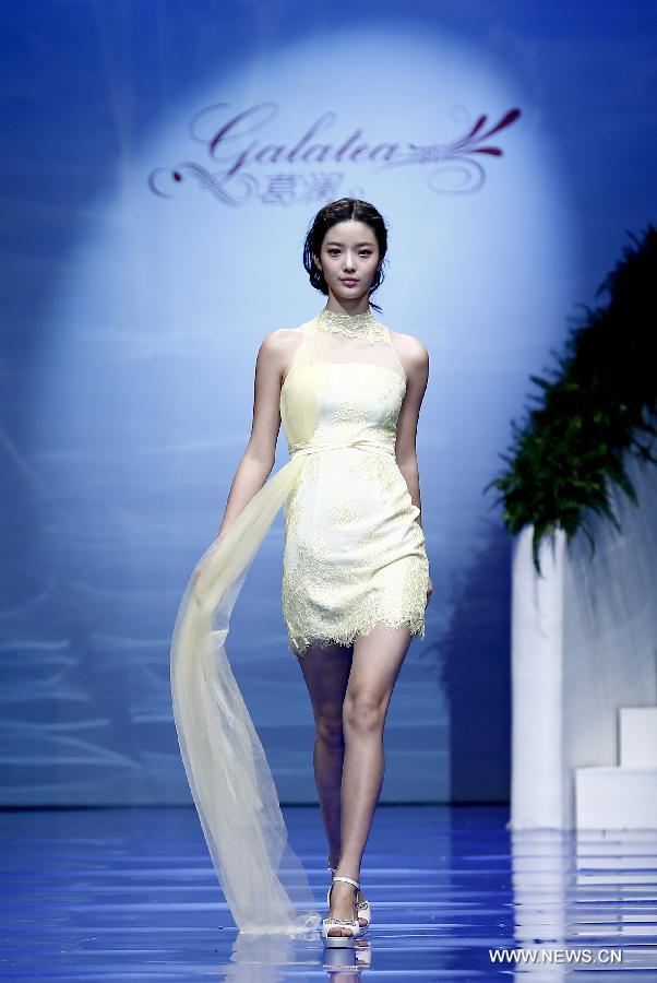 A model presents a wedding gown designed by Ren Chunhua during China Fashion Week in Beijing, capital of China, Oct. 26, 2014.