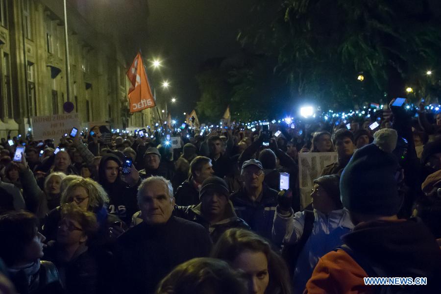 Thousands of demonstrators hold their phones in the air to protest against the planned internet tax in front of the Economy Ministry building in Budapest, Hungary on October 26, 2014. 