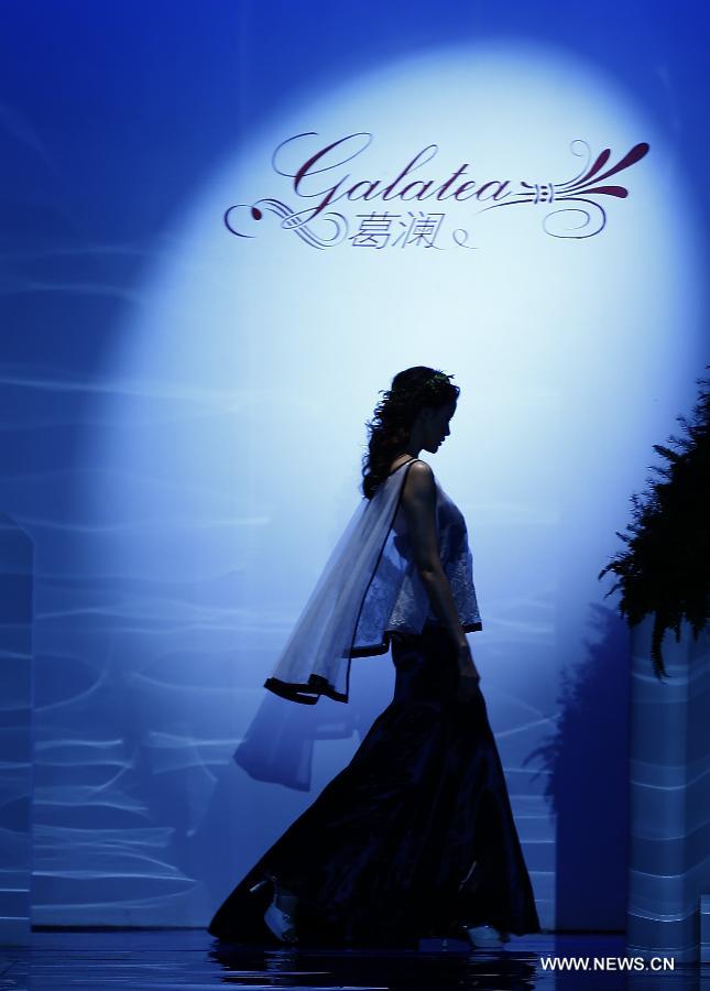 A model presents a wedding gown designed by Ren Chunhua during China Fashion Week in Beijing, capital of China, Oct. 26, 2014. 