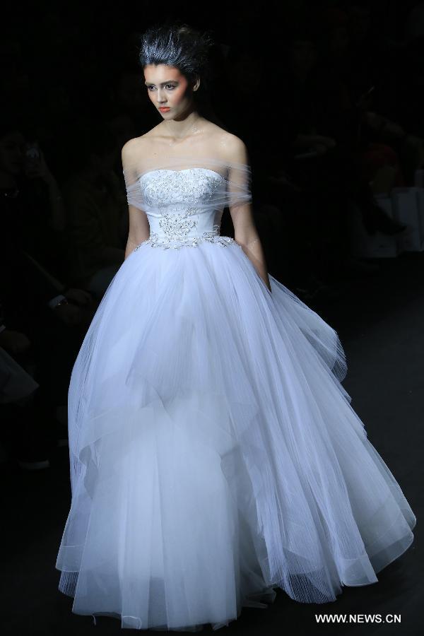 A model presents a wedding gown designed by Peng Jing during China Fashion Week in Beijing, capital of China, Oct. 26, 2014.