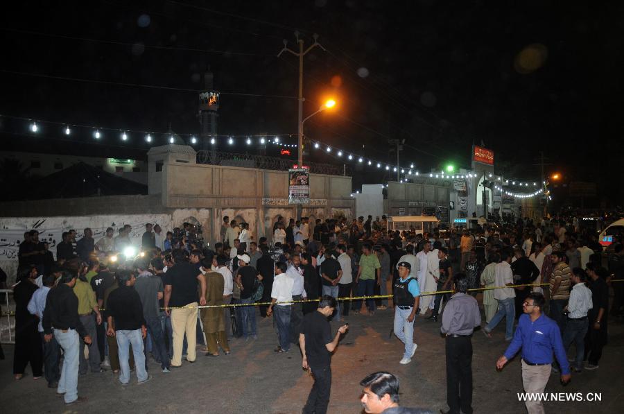 People gather at the blast site in southern Pakistani port city of Karachi on Oct. 28, 2014. 