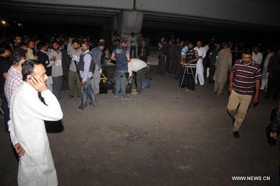 Pakistani security officials examine the blast site in southern Pakistani port city of Karachi on Oct. 28, 2014. 