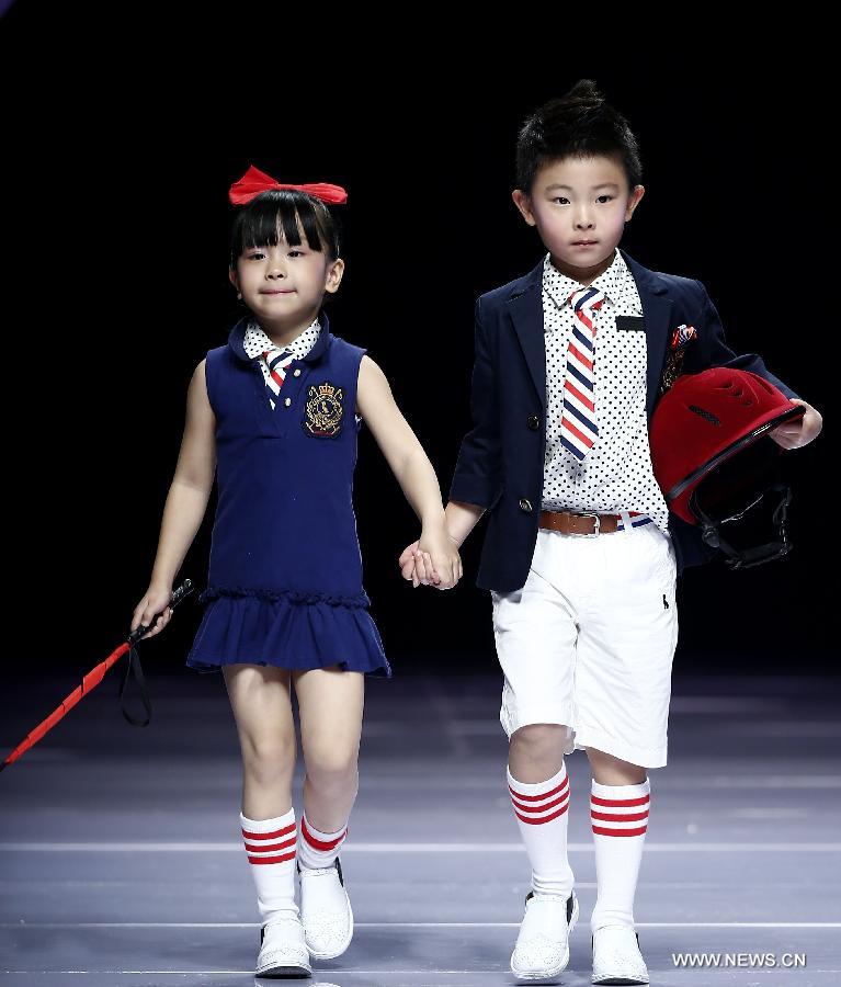 Child models present creations designed by Dong Wenmei during China Fashion Week in Beijing, capital of China, Oct. 29, 2014. [Xinhua]