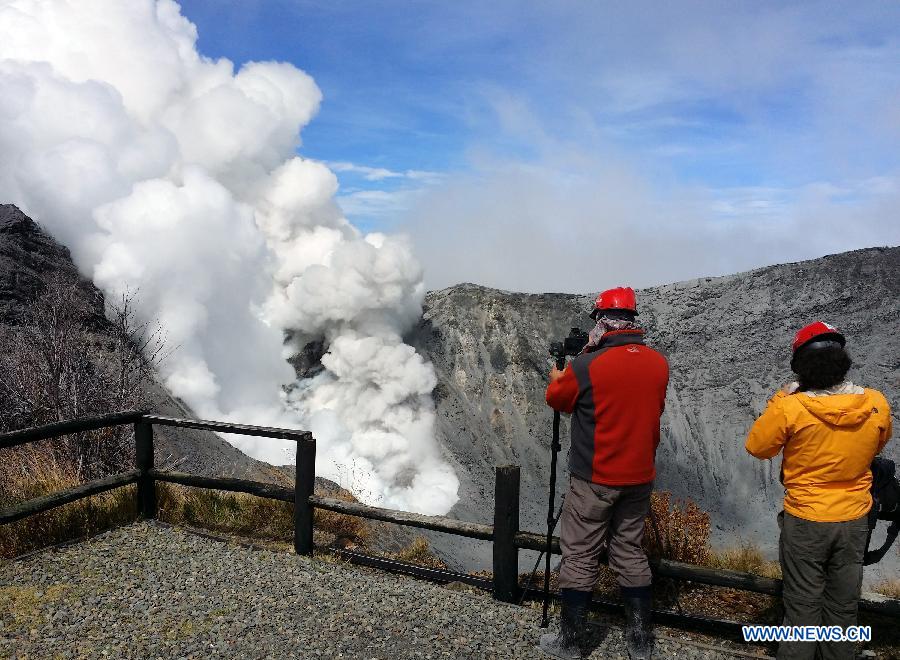 Image provided by the Seismological National Network of members of the Seismological National Network taking pictures of the Turrialba Volcano, near Santa Cruz de Turrialba, 65km northeast of San Jose, capital of Costa Rica, on Oct. 30, 2014. 