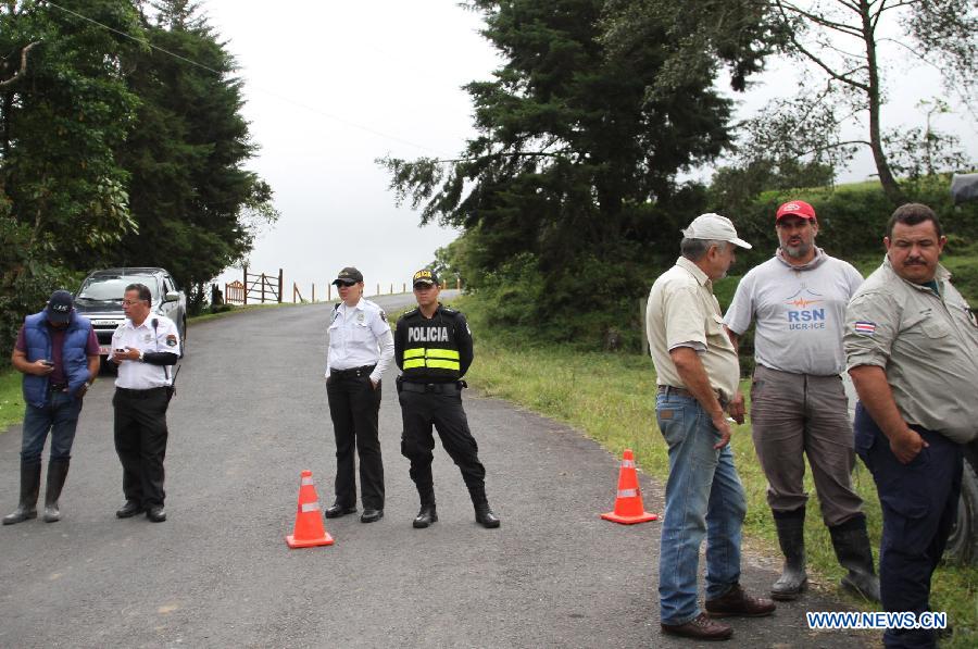 Officials of the National Emergencies Commission stand guard during a blockade towards the Turrialba Volcano, near Santa Cruz de Turrialba, 65km northeast of San Jose, capital of Costa Rica, on Oct. 30, 2014.