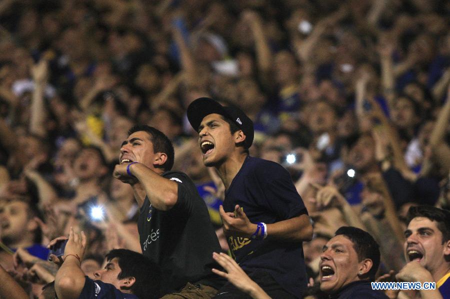 Fans of Argentina's Boca Juniors yell during the first leg of the quarterfinals of the South American Cup against Paraguay's Cerro Porteno at Alberto J. Armando stadium, in Buenos Aires city, Argentina, on Oct. 30, 2014.