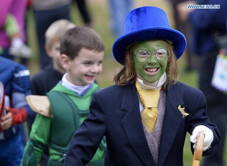 Students attend a Halloween parade at Glebe Elementary School in Arlington, Virginia, the United States, Oct. 31, 2014. 