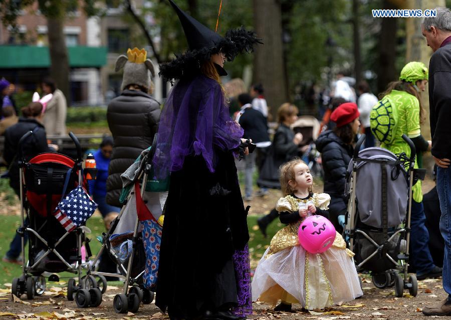 Children dressed in Halloween costume take part in Halloween Parade in New York, the United States, on Oct. 31, 2014. The annual Children's Halloween Parade is held here to celebrate Halloween on Friday. 