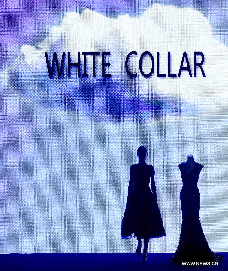 A model presents a creation at the closing ceremony of the China Fashion Week in Beijing, capital of China, Nov. 2, 2014. 