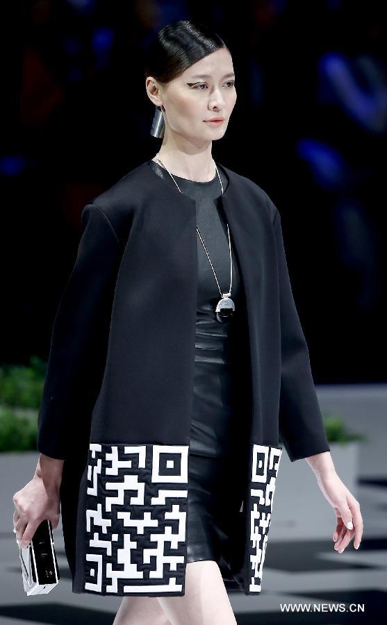 A model presents a creation at the closing ceremony of the China Fashion Week in Beijing, capital of China, Nov. 2, 2014. 