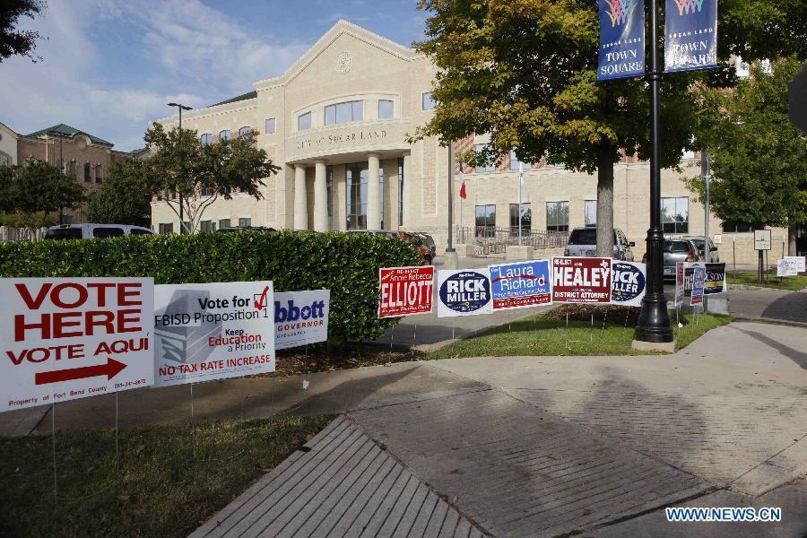 Campaign signs are seen outside a polling station in Sugar Land, the United States, Nov. 4, 2014.