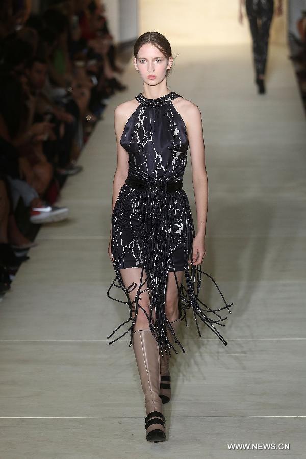 Models present creations of 'Lolitta' 2015 collection during 38th Sao Paulo Fashion Week (SPFW) held in Sao Paulo, Brazil, on Nov. 4, 2014.