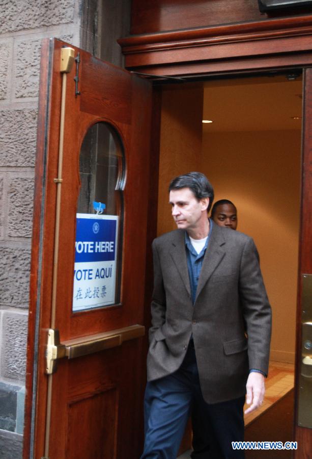 A registered elector leaves a polling station after casting his vote during the Midterm Elections in New York, the United States, on Nov. 4, 2014. 