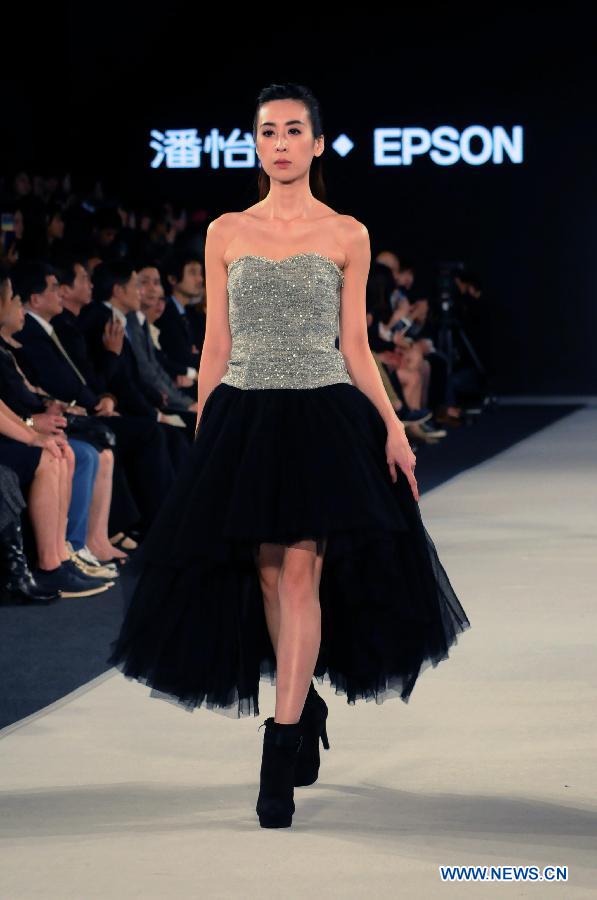 A model presents a creation designed by Gioia Pan in Taipei, southeast China, Nov. 6, 2014.