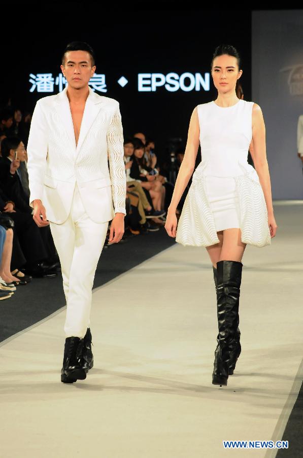 Models present creations designed by Gioia Pan in Taipei, southeast China, Nov. 6, 2014. 