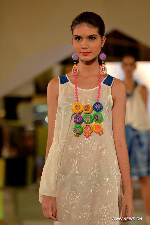 A model presents a creation by Indonesian designer Lenny Agustin during the Jakarta Fashion Week 2015, in Jakarta, Indonesia, Nov. 7, 2014. The event runs from Nov. 1 to Nov. 7. 