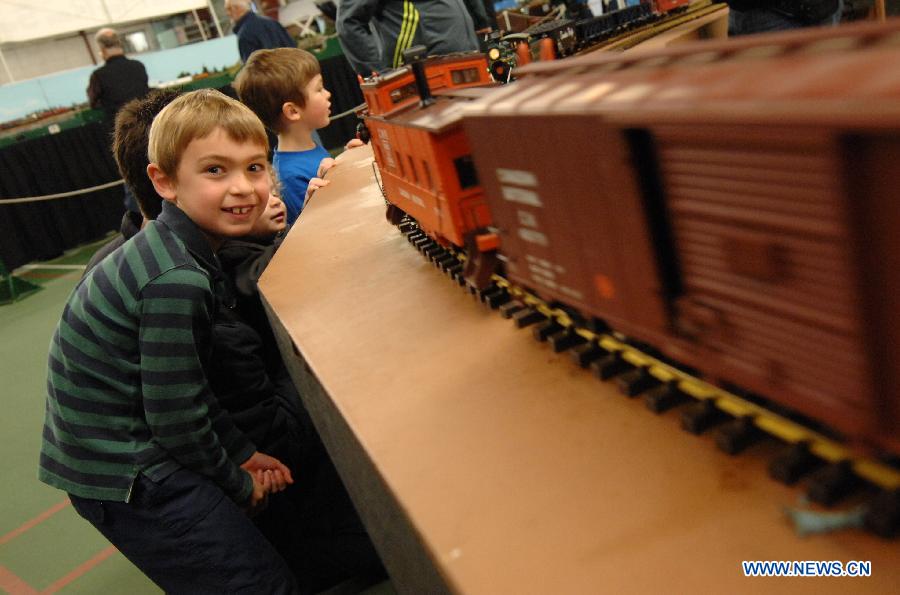 A boy watches model trains during the 32nd Model Railway Exhibition 'Trains 2014' in Burnaby, Canada, Nov. 8, 2014. 