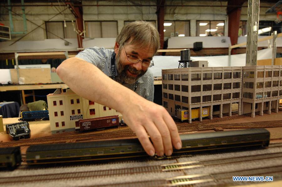 An exhibitor prepares model trains to run during the 32nd Model Railway Exhibition 'Trains 2014' in Burnaby, Canada, Nov. 8, 2014.