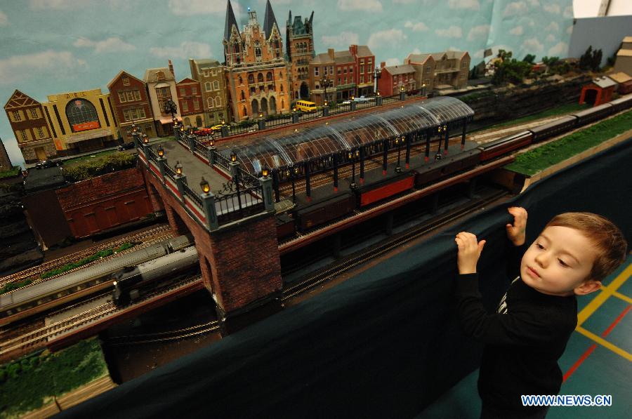 A boy watches model trains during the 32nd Model Railway Exhibition 'Trains 2014' in Burnaby, Canada, Nov. 8, 2014. 