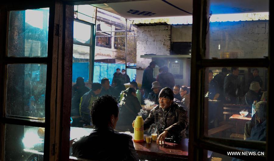 Customers drink sweet tea at a teahouse named Guangming in Lhasa, capital of southwest China's Tibet Autonomous Region, Nov. 11, 2014.