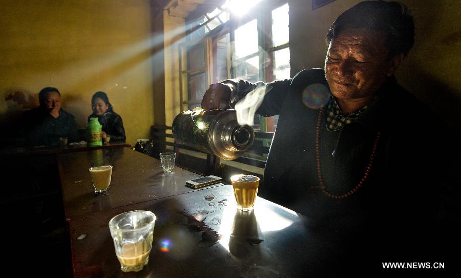 Customers drink sweet tea at a teahouse named Guangming in Lhasa, capital of southwest China's Tibet Autonomous Region, Nov. 11, 2014. 