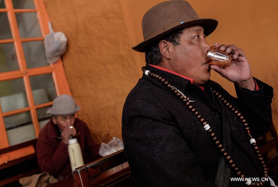 Customers drink sweet tea at a teahouse named Canggusi in Lhasa, capital of southwest China's Tibet Autonomous Region, Nov. 11, 2014. 