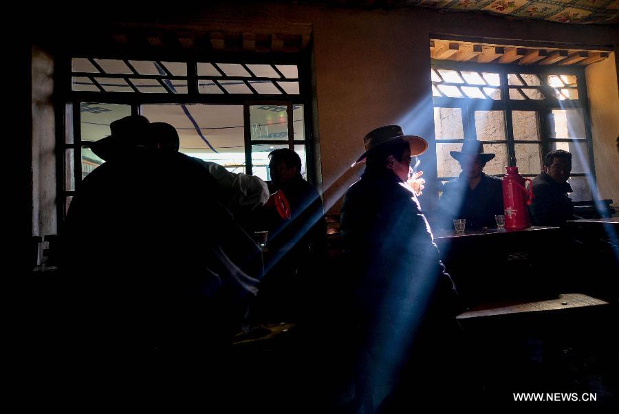 Customers drink sweet tea at a teahouse named Guangming in Lhasa, capital of southwest China's Tibet Autonomous Region, Nov. 11, 2014. 