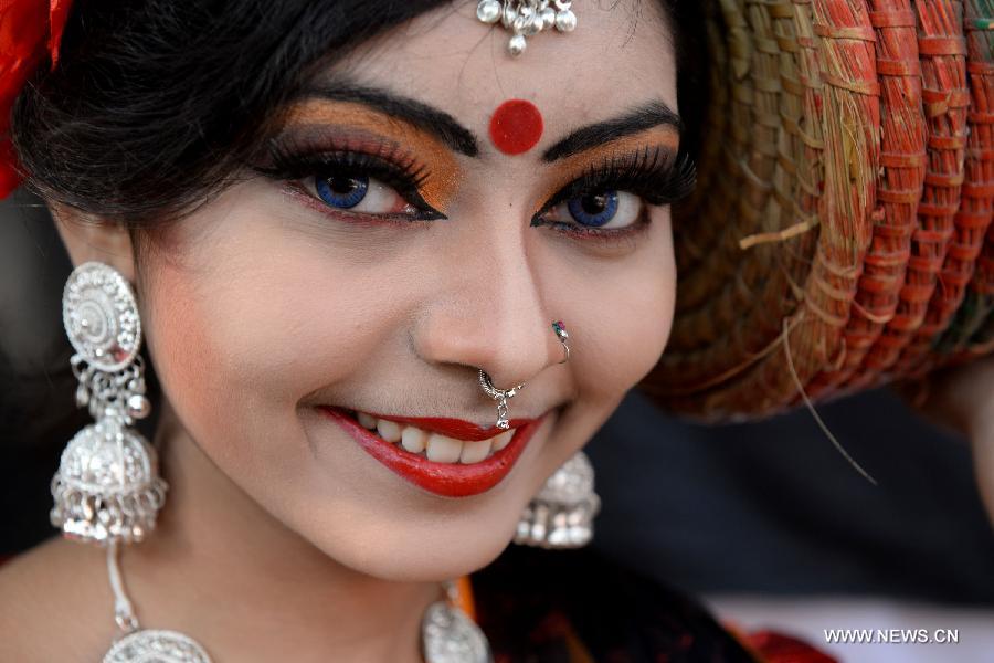 Bangladeshi people celebrate the traditional harvest festival on the first day of Agrahayan, a month of Bengali calendar, that falls on Saturday.