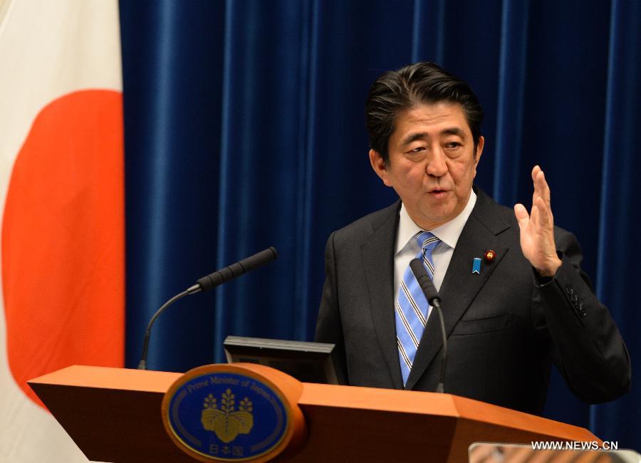 Japanese Prime Minister Shinzo Abe addresses a press conference in Tokyo, Japan, Nov. 18, 2014. 