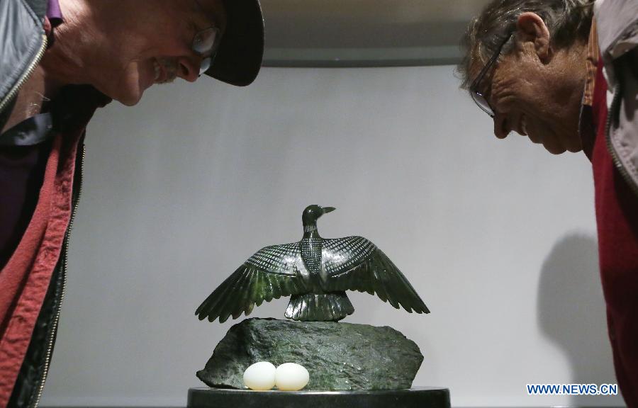 Residents look at a jade sculpture at the World Jade Symposium in Vancouver, Canada, Nov. 21, 2014.