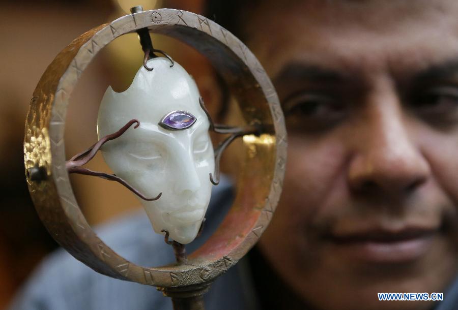 A jade collector displays a jade carving at the World Jade Symposium in Vancouver, Canada, Nov. 21, 2014.