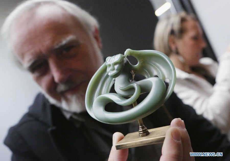 A jade collector displays a jade carving at the World Jade Symposium in Vancouver, Canada, Nov. 21, 2014.