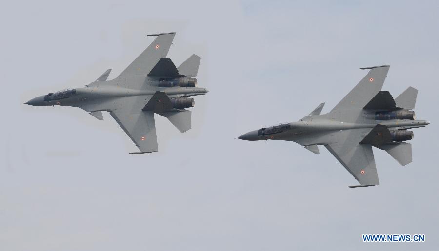 Two Indian Air Force (IAF) Sukhoi Su-30 fighter aircrafts fly during a parade at an airbase in Tezpur, India, on Nov. 21, 2014.