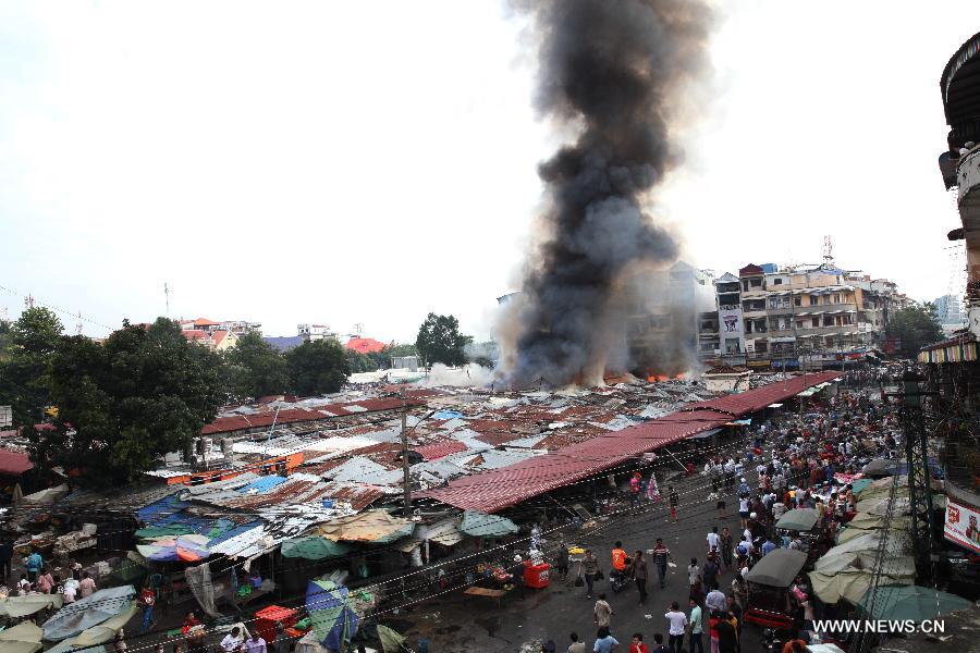 Fire and smoke engulf the Old Market in Phnom Penh, Cambodia, Nov. 24, 2014.