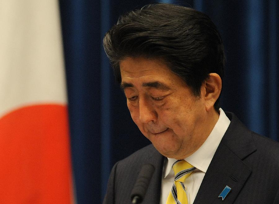 Japanese Prime Minister Shinzo Abe bites his lips during a press conference at his official residence in Tokyo, Japan, Nov. 21, 2014. Japan dissolved the House of Representatives, or the lower house in its bicameral parliament, on Friday for a general election slated for Dec. 14,with Prime Minister Shinzo Abe's economic policies dubbed 'Abenomics' and other polices to be tested in the looming vote.(Xinhua/Stringer)