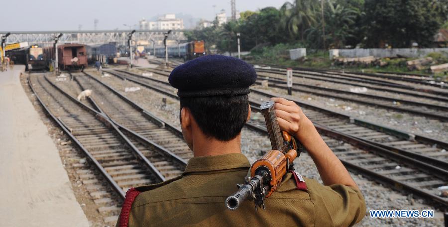 A security person patrols over the railway track after a powerful explosive was recovered from the Guwahati bound Inter-City express in Kedukona Railway station in Assam, India, Nov. 24, 2014. 