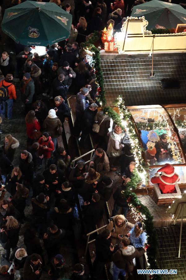 People visit the Christmas market after its official opening in Frankfurt, Germany, Nov. 26, 2014.