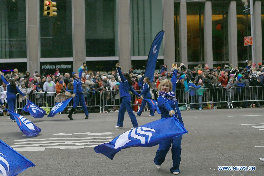 People attend the 88th Macy's Thanksgiving Day Parade in New York, the United States, Nov. 27, 2014.