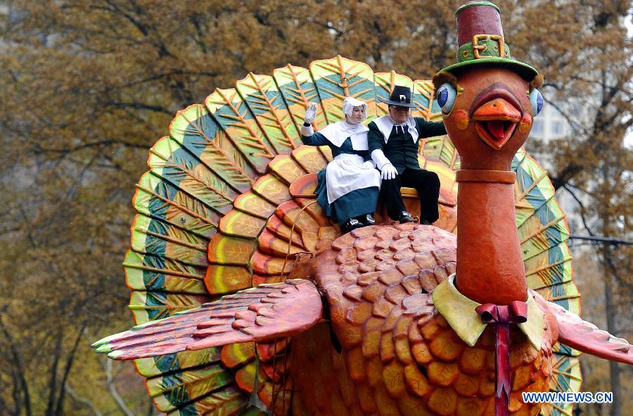 People attend the 88th Macy's Thanksgiving Day Parade in New York, the United States, Nov. 27, 2014.