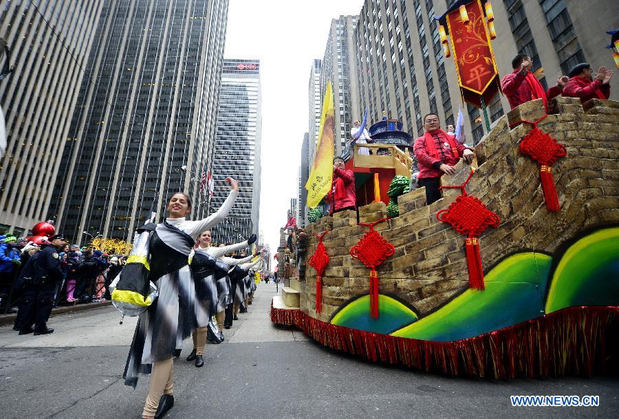 People attend the 88th Macy's Thanksgiving Day Parade in New York, the United States, Nov. 27, 2014.