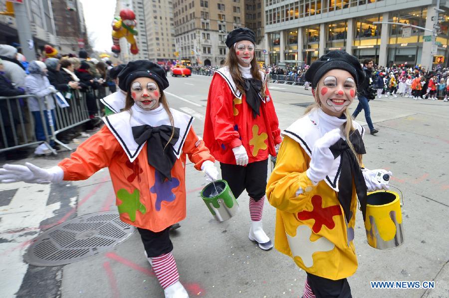 People attend the 88th Macy's Thanksgiving Day Parade in New York, the United States, Nov. 27, 2014.