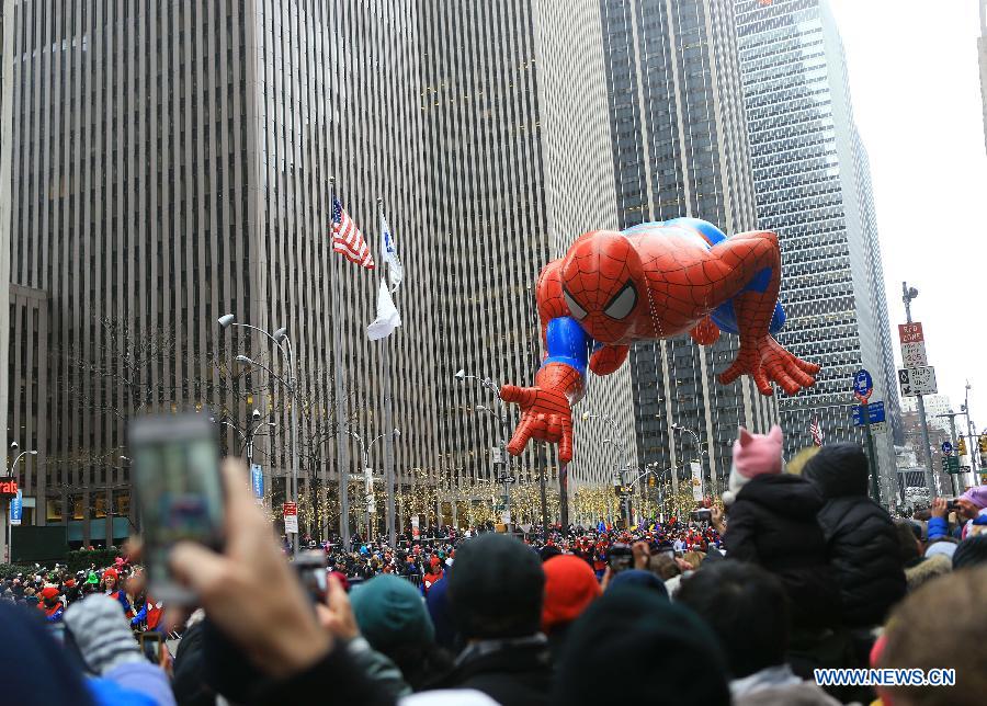 People attend the 88th Macy's Thanksgiving Day Parade in New York, the United States, Nov. 27, 2014.