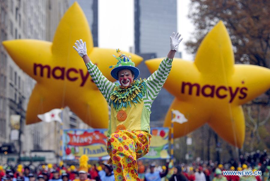 People attend the 88th Macy's Thanksgiving Day Parade in New York, the United States, Nov. 27, 2014.